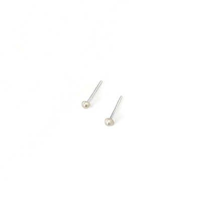 Pair of pearl stud earrings on a white background