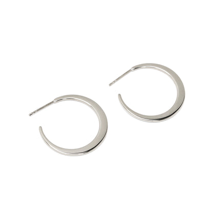 Pair of silver hoop earrings on a white background