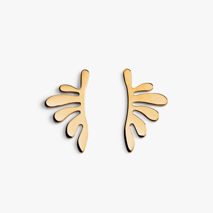 Pair of gold plant leaf shaped earrings against a white background
