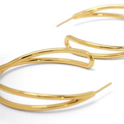 Gold hoop earrings on a white background