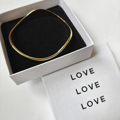Gold bracelet in white box