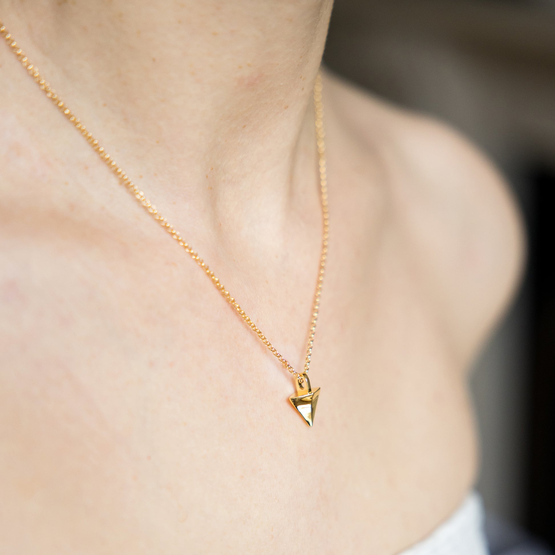 Gold necklace with a triangular pendant