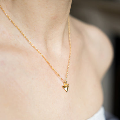 Gold necklace with a triangular pendant