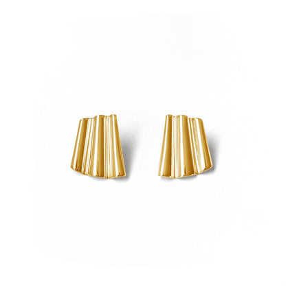 Pair of gold earrings on a white background