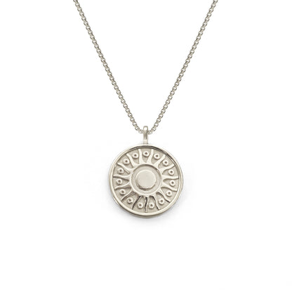 Silver necklace with a round pendant on a white background