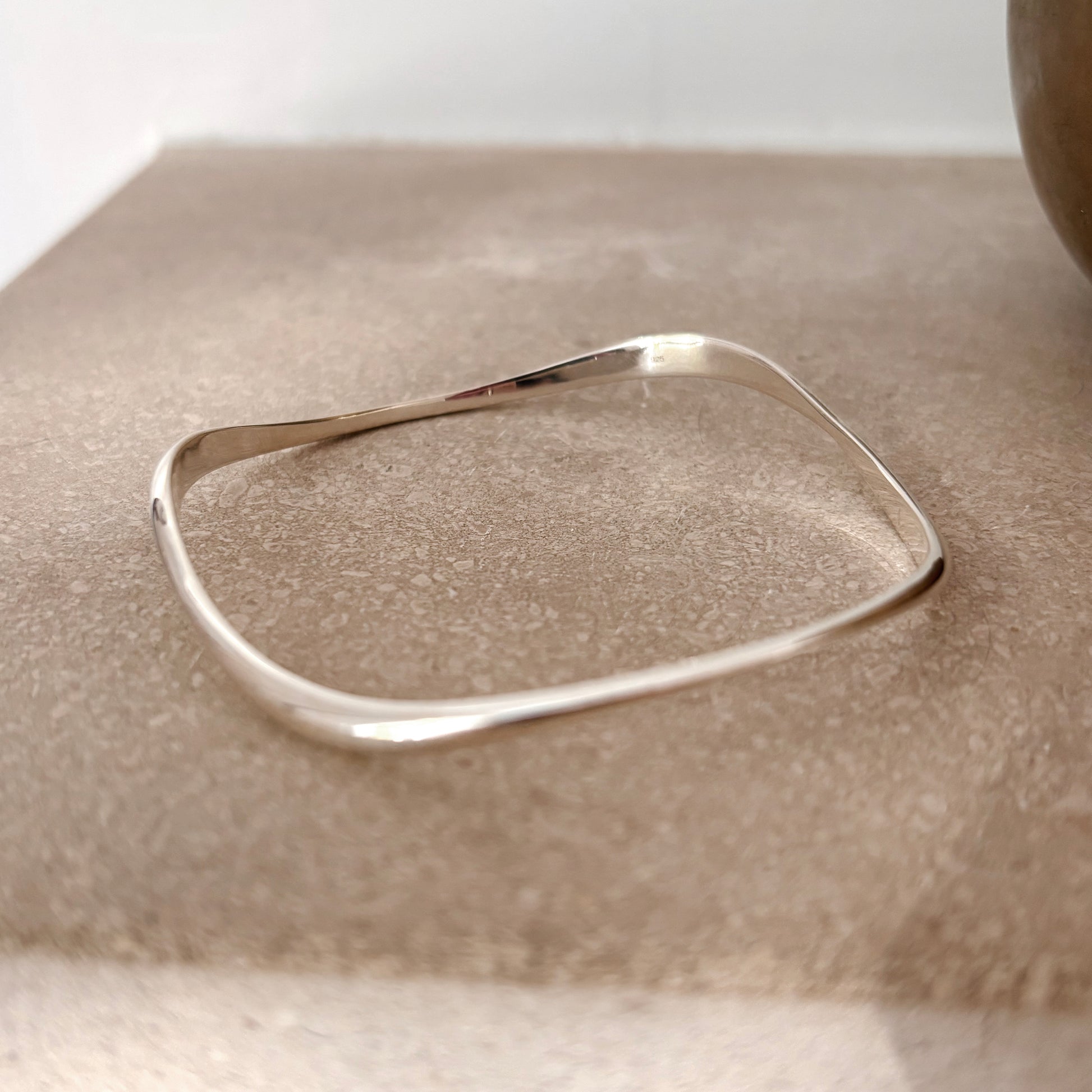 Silver bracelet on a textured surface