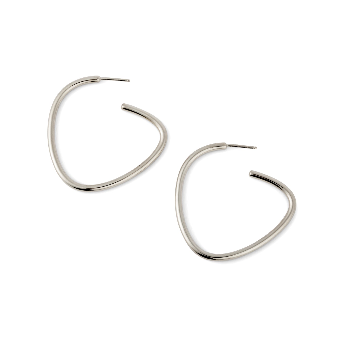 A pair of silver-colored curved hoop earrings against a white background.