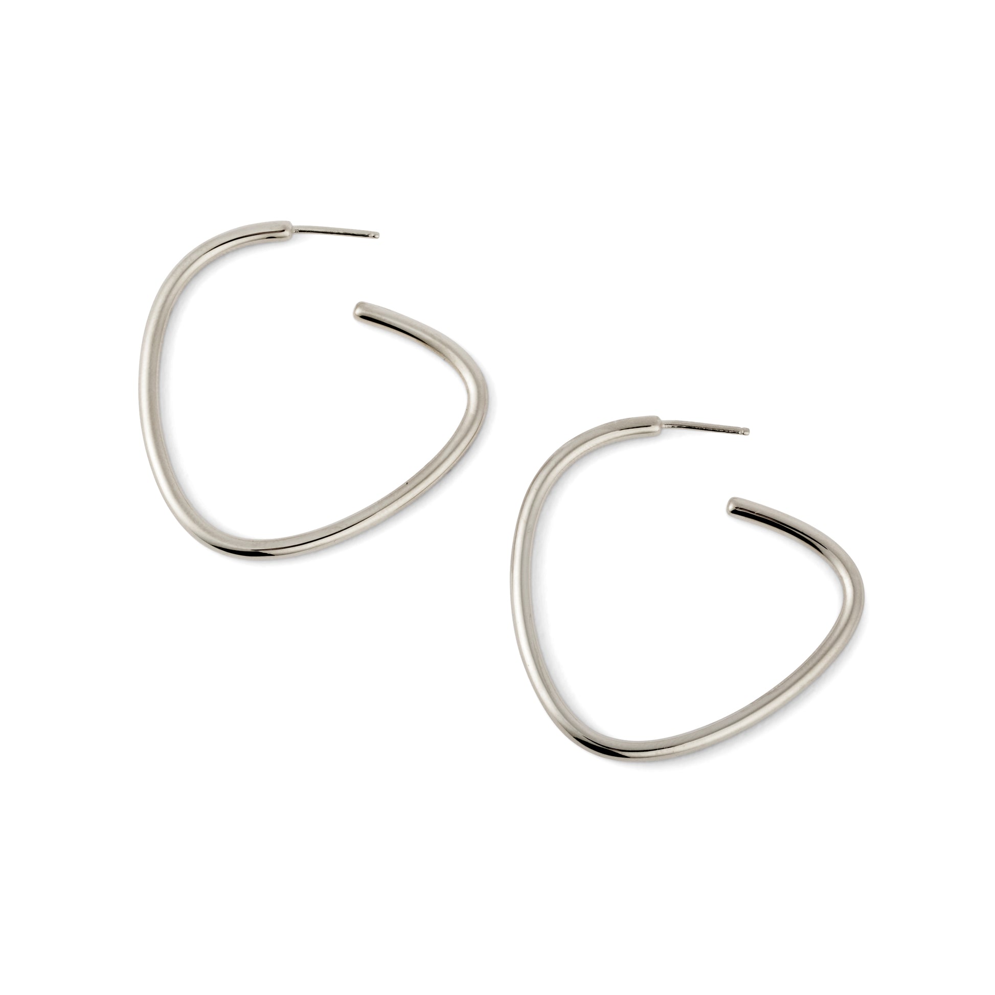 A pair of silver-colored curved hoop earrings against a white background.