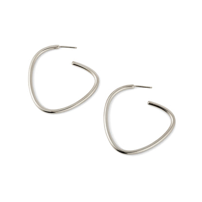 A pair of silver-colored curved hoop earrings against a white background.