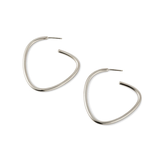 A pair of silver-colored curved hoop earrings against a white background.
