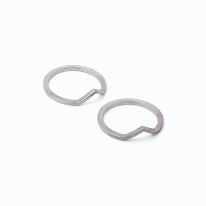 Pair of silver stacking rings with peak designs on a white background