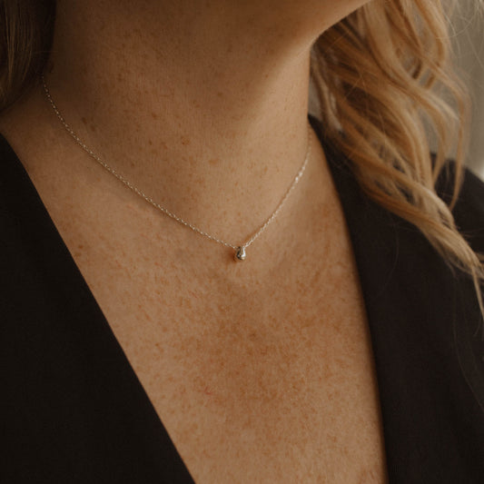 Silver Droplet Water Drop necklace on woman's neck