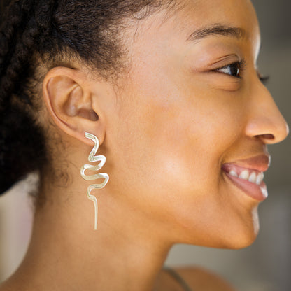 Close-up of a woman wearing a silver earring