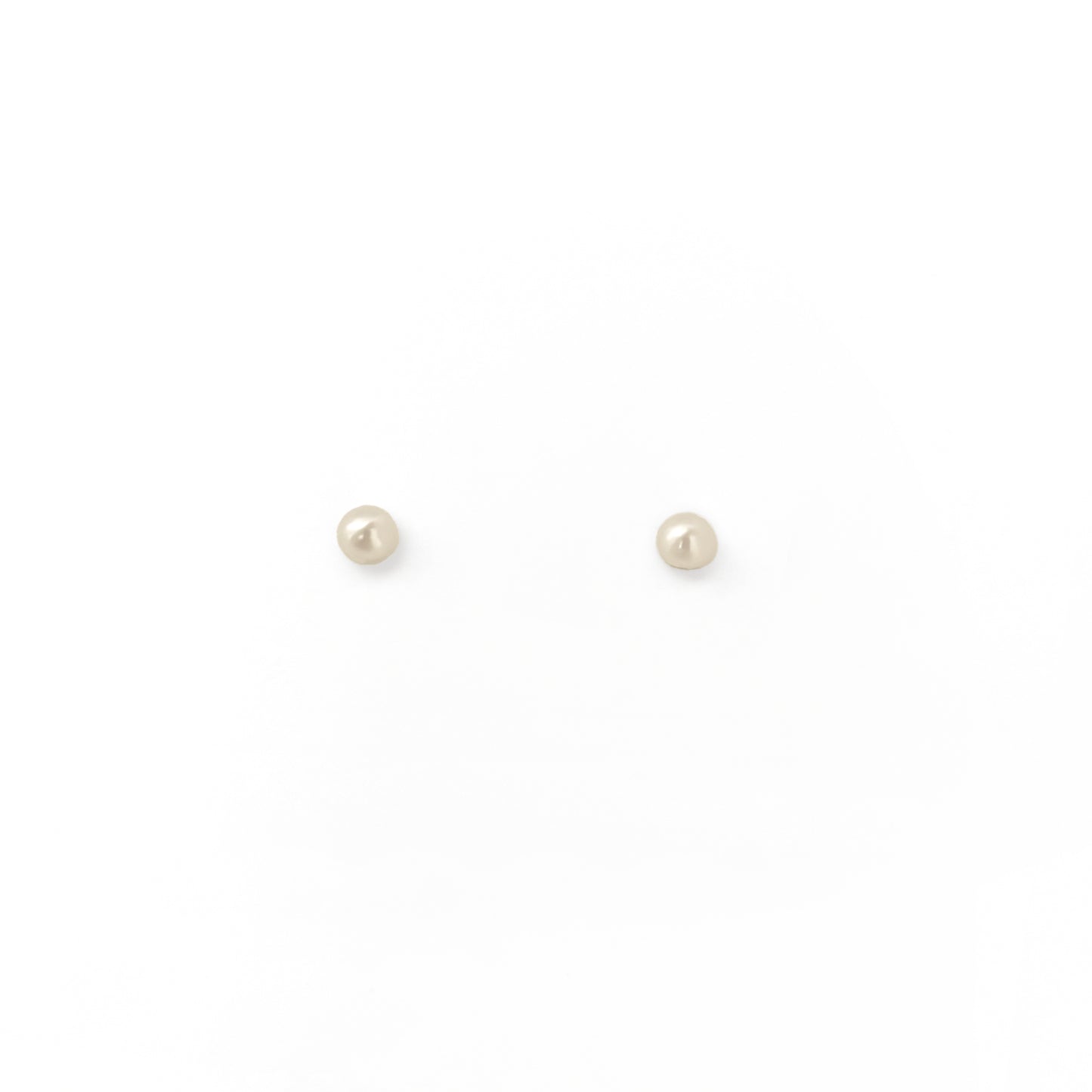 Pair of small pearl stud earrings on a white background