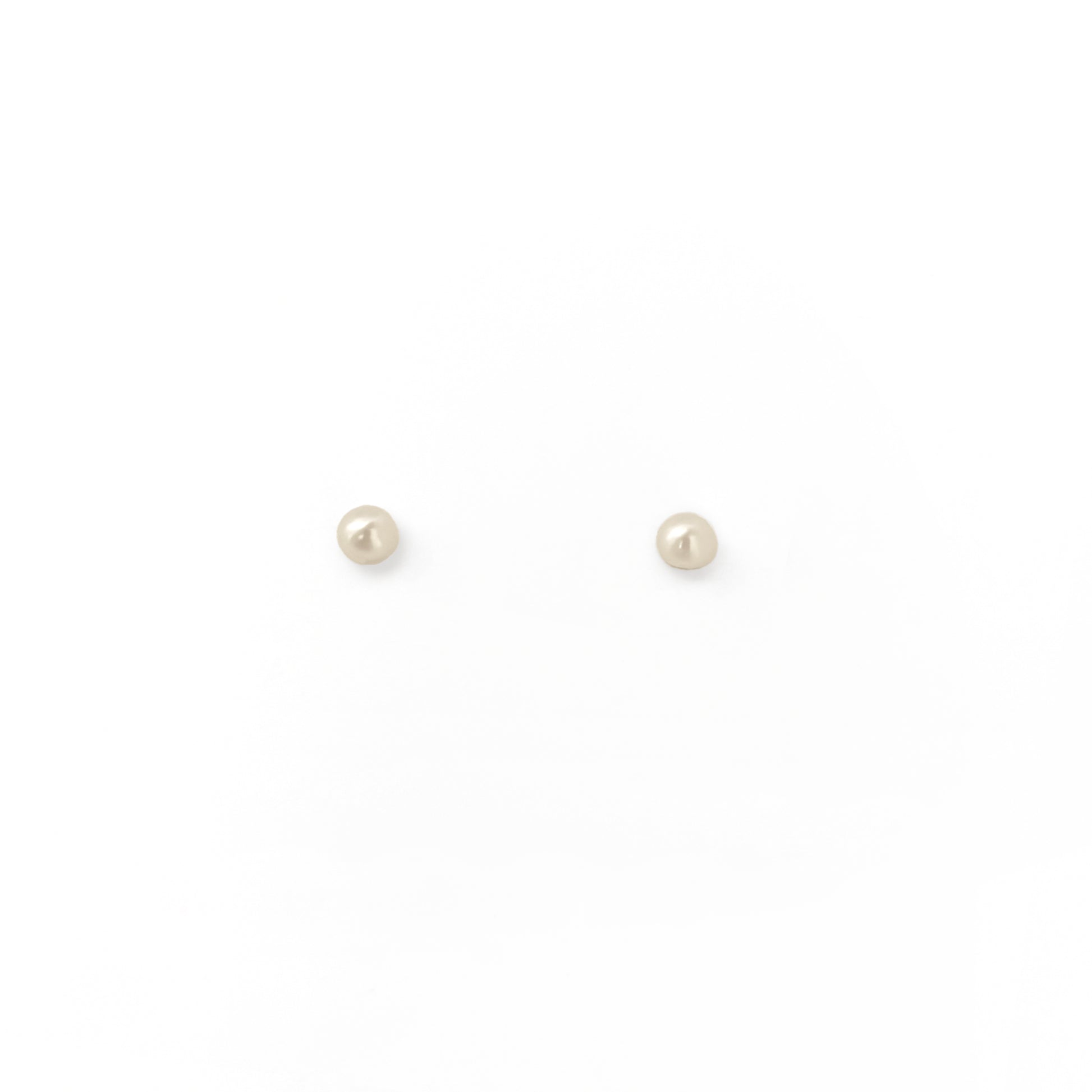 Pair of small pearl stud earrings on a white background