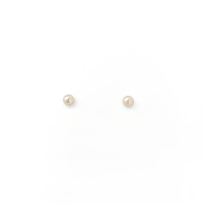 Pair of small pearl stud earrings on a white background