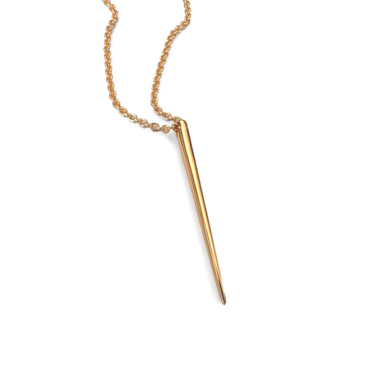 A gold-colored spike-shaped pendant necklace on a rolo-style chain.