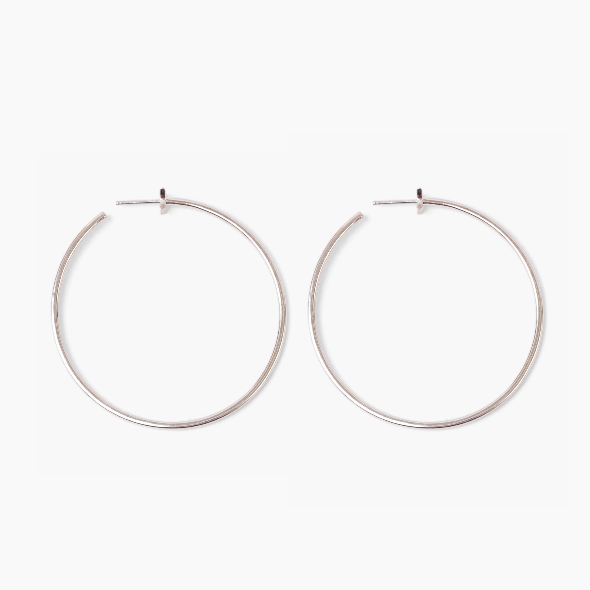 Pair of silver hoop earrings on a white background