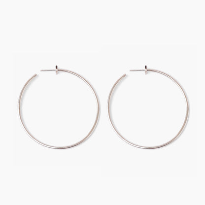 Pair of silver hoop earrings on a white background
