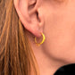 Sun Moon Bohemian Hoop Earrings in Gold on woman's ear, close up view