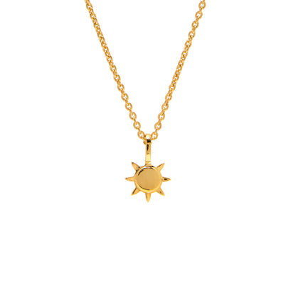 Gold Sun Necklace Pendant hanging on gold chain with white background
