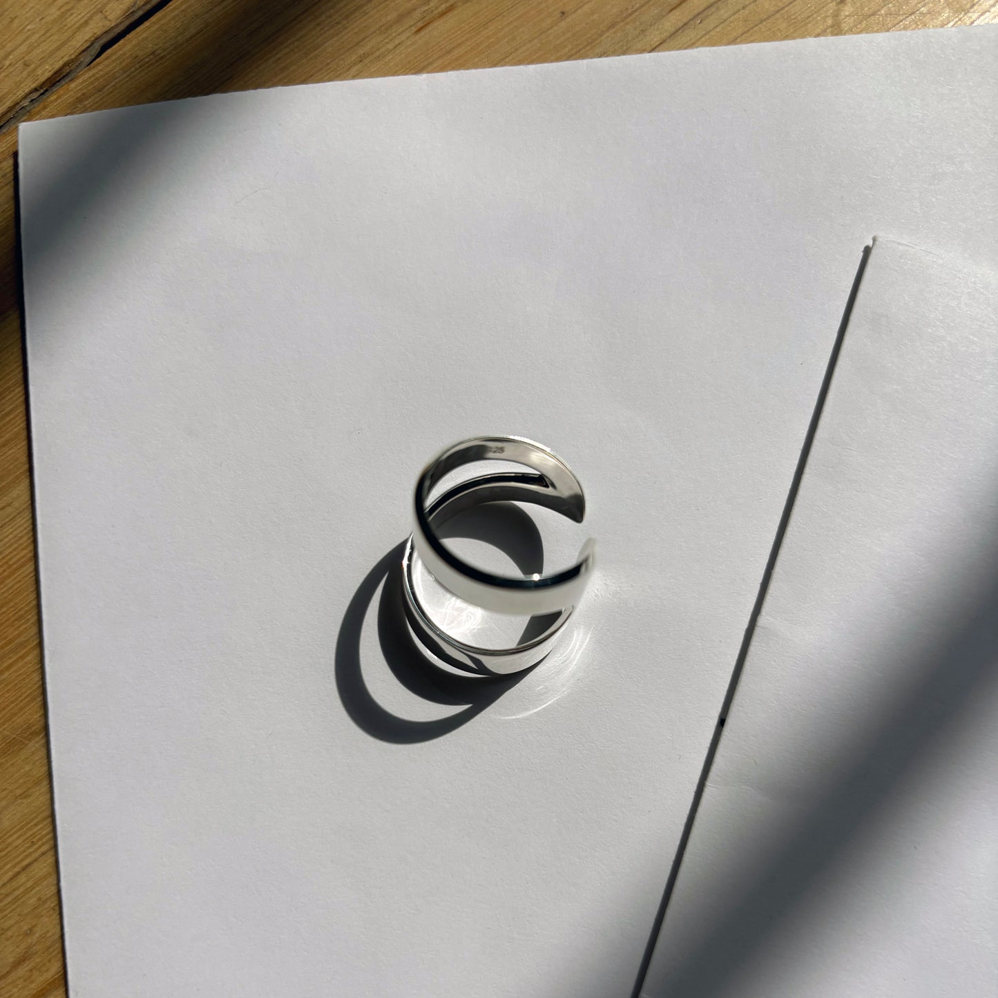 Silver ring on a white sheet of paper