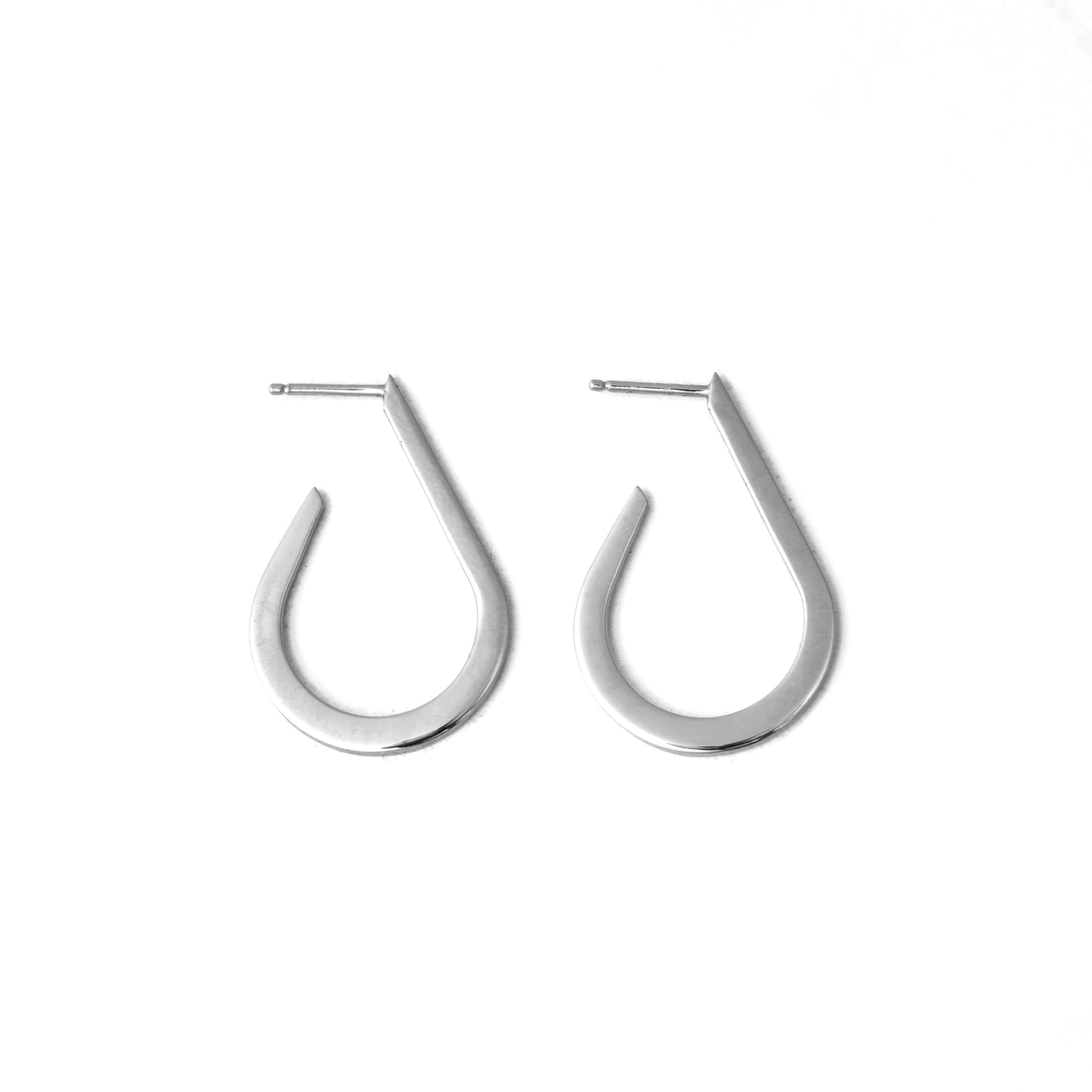 A pair of silver-colored curved droplet earrings on a white background.