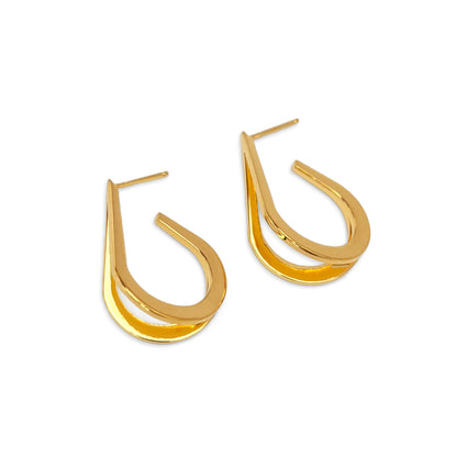 Gold hoop earrings on a white background