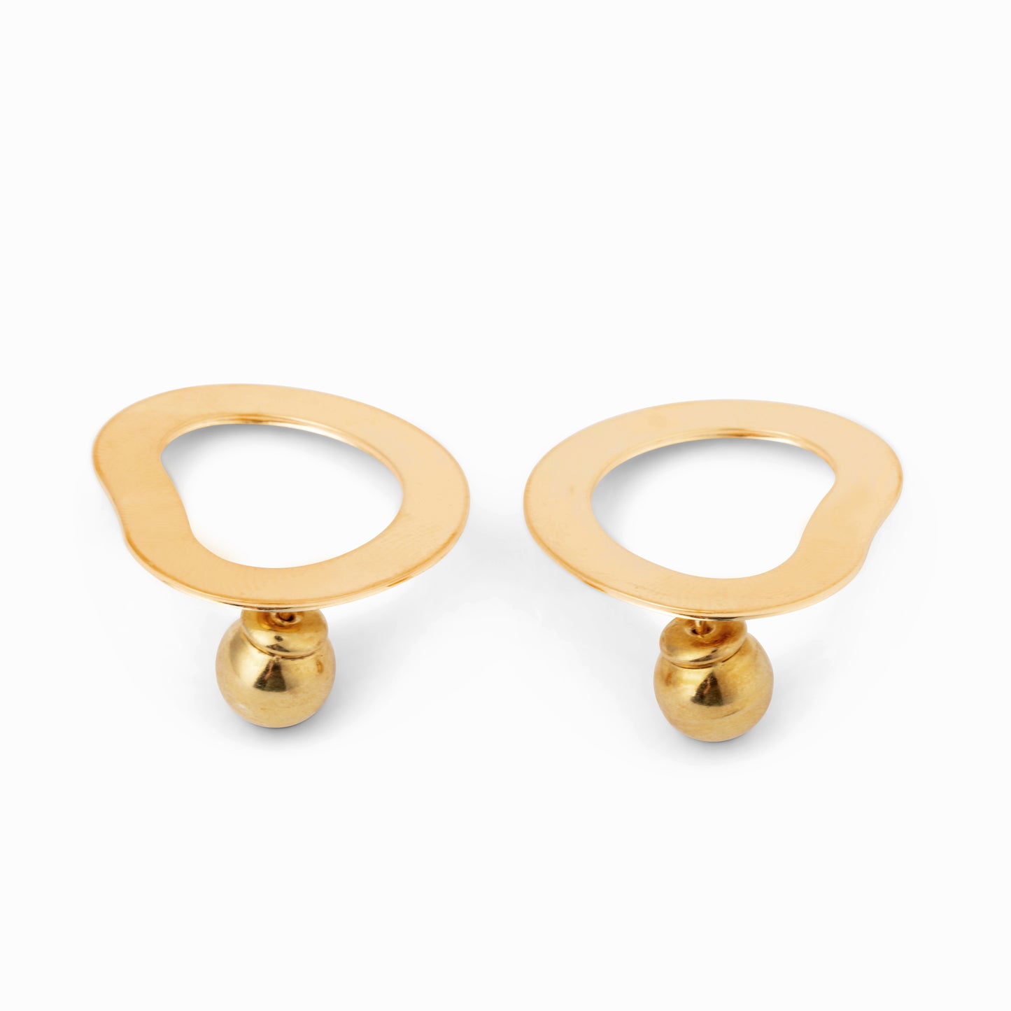 Pair of geometric gold circular earrings against a white background