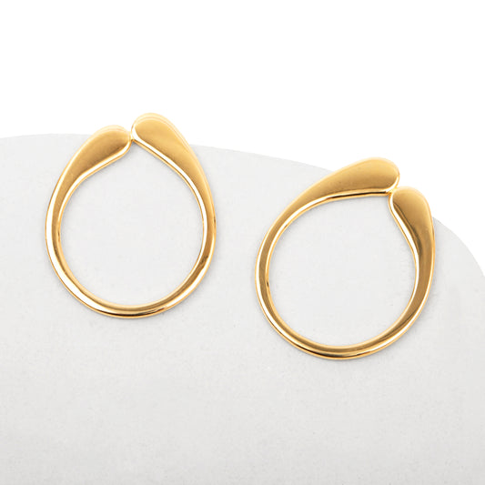A pair of gold-colored hoop earrings with a drip-like detail at the top, displayed against a white background.