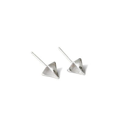 A pair of small, silver, pointed stud earrings against a white background.