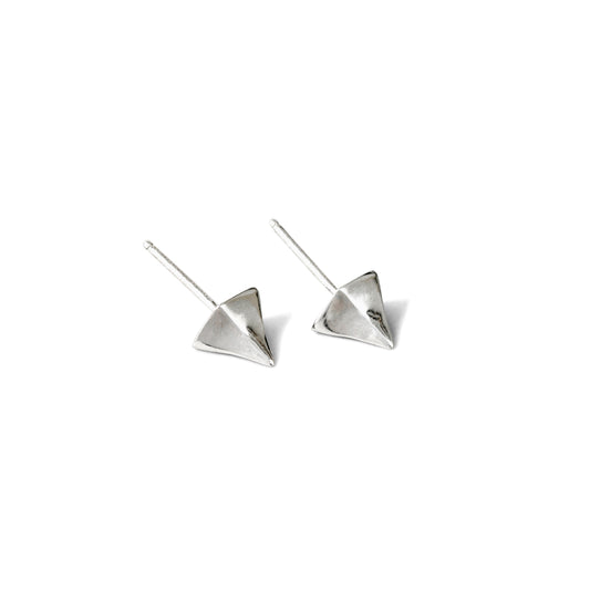 A pair of small, silver, pointed stud earrings against a white background.