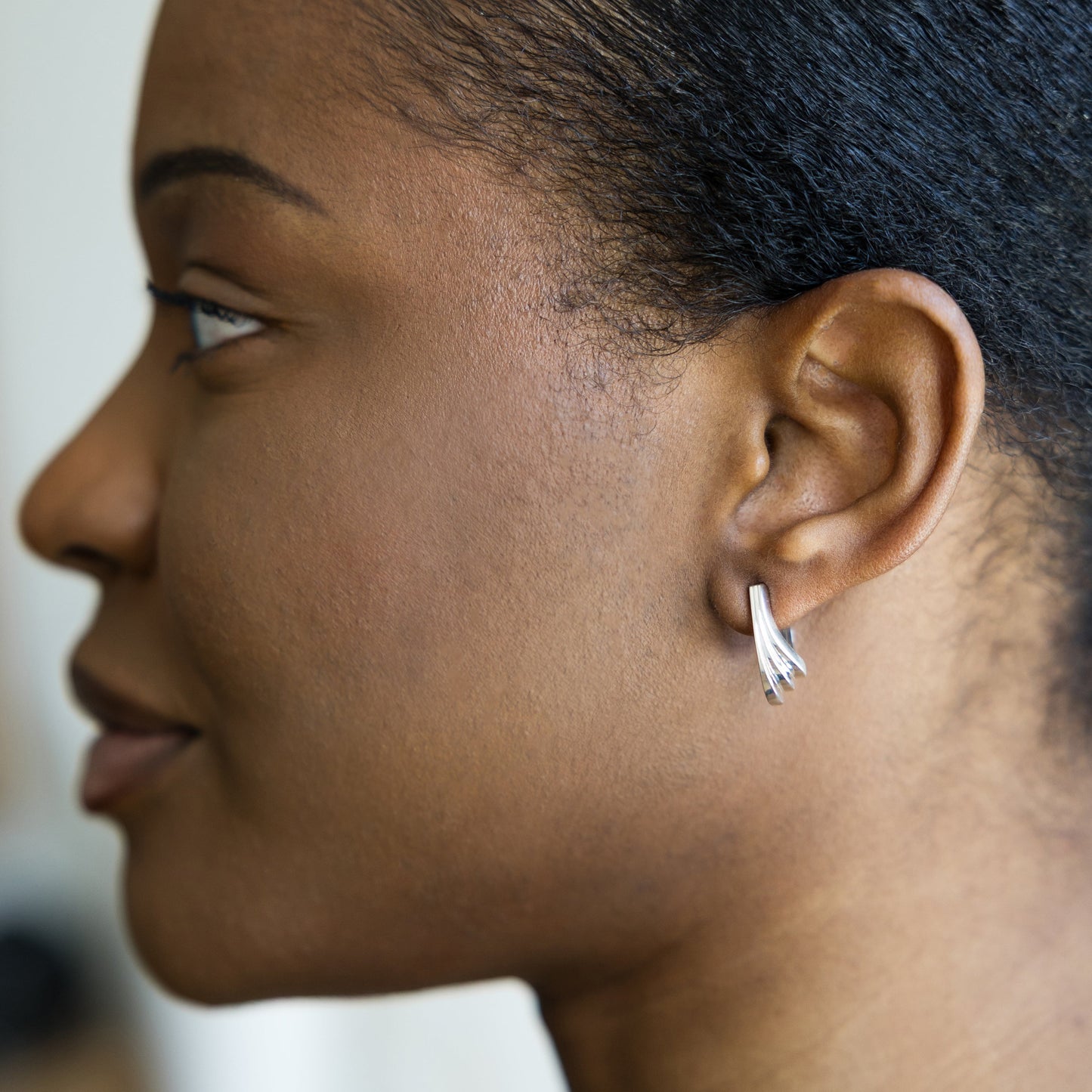 Close-up of a person wearing a silver earring.