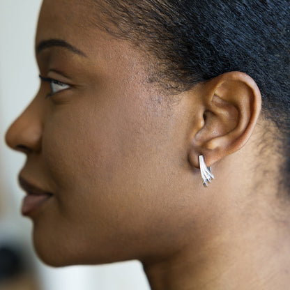 Close-up of a person wearing a silver earring.