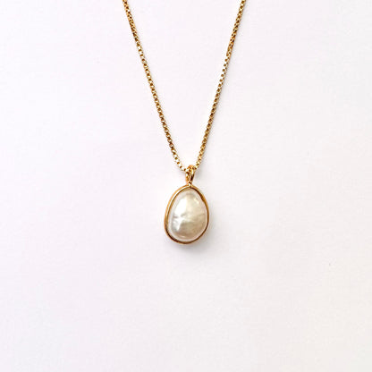 A baroque pearl necklace with a gold vermeil setting on a box-style chain.