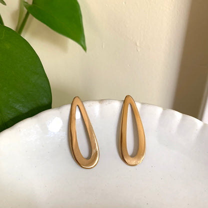 Pair of gold earrings on a white background.